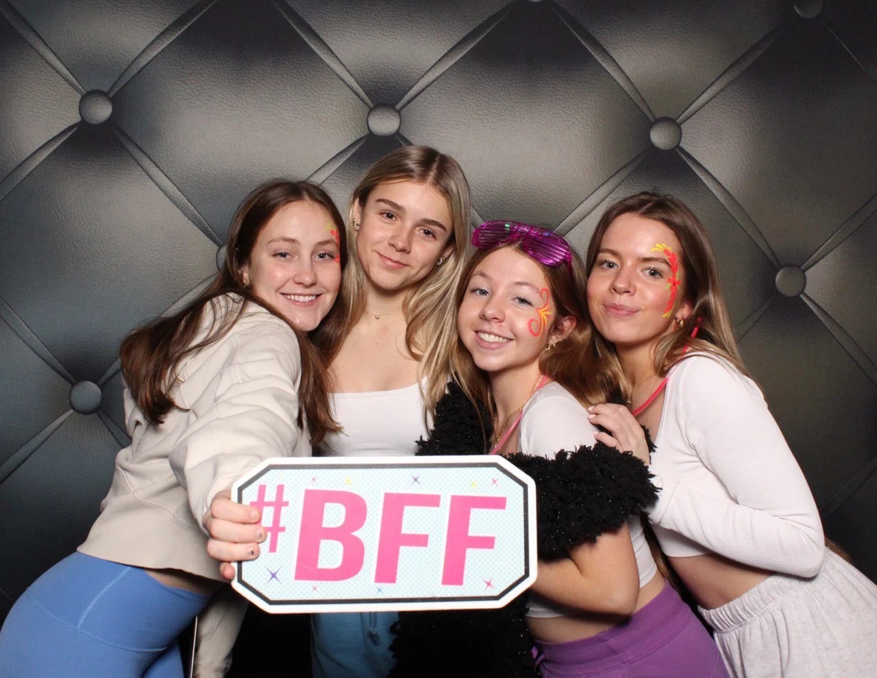 Friends having fun in photo booth